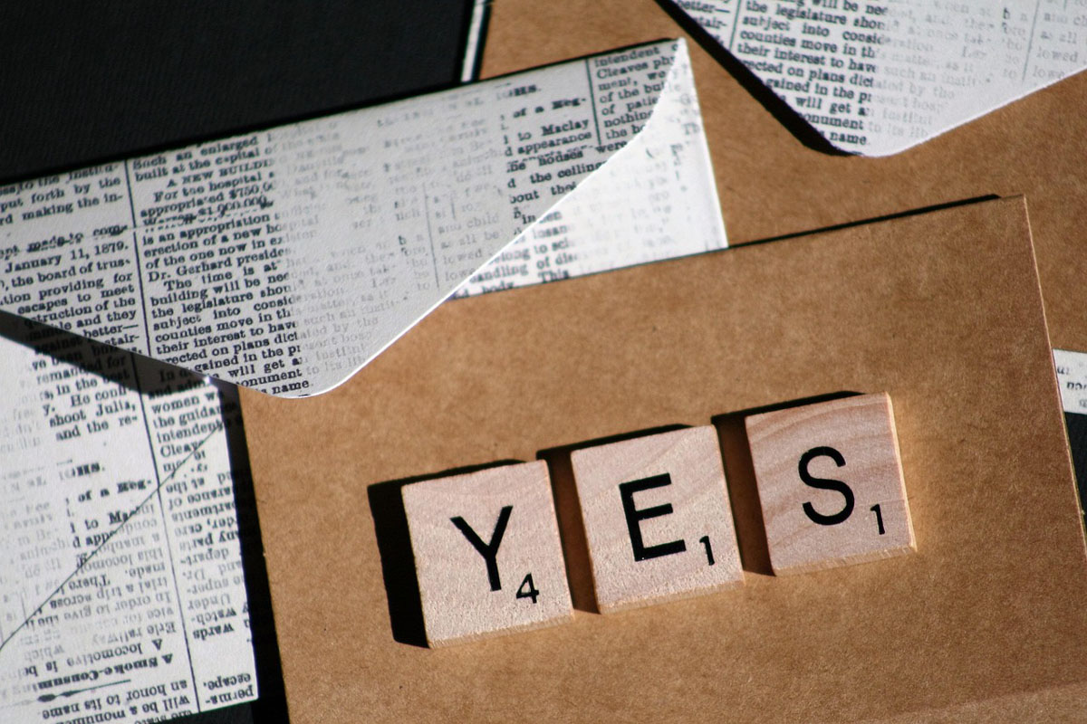 Scrabble letters that spell "yes" on vintage envelopes